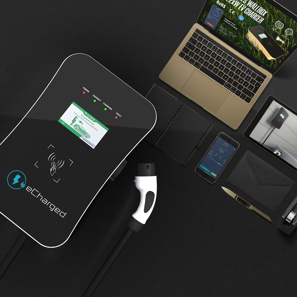 eCharged B3M 11kW electric vehicle charger with Type 2 plug displayed alongside laptop, smartphone, and tablets on black surface